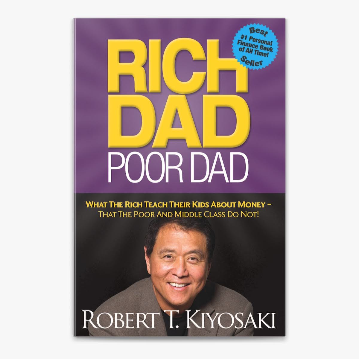 A purple book cover featuring the title Rich Dad Poor Dad in bold yellow. At the bottom, a large portrait of the author, smiling confidently.