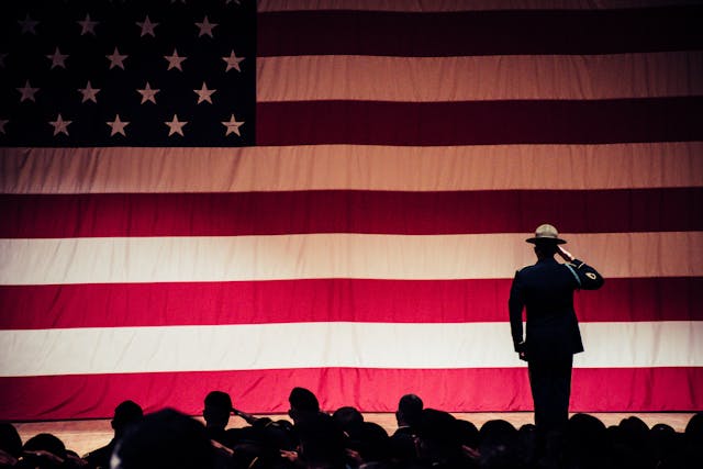 Photo by Brett Sayles: https://www.pexels.com/photo/man-standing-on-stage-facing-an-american-flag-1340504/