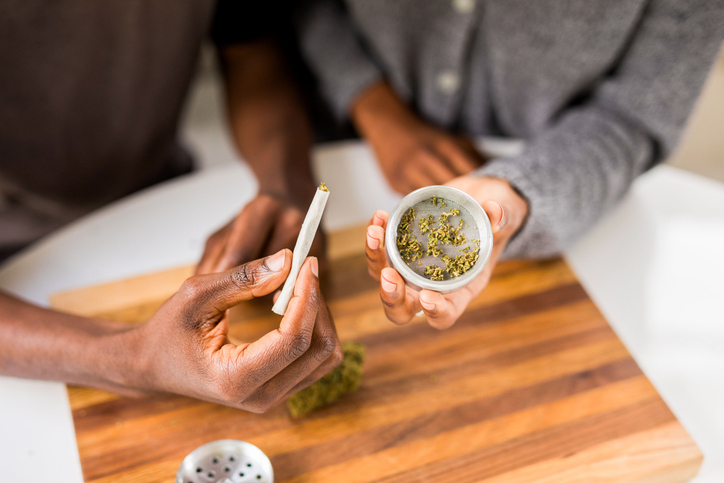 Hands preparing cannabis joint photo
