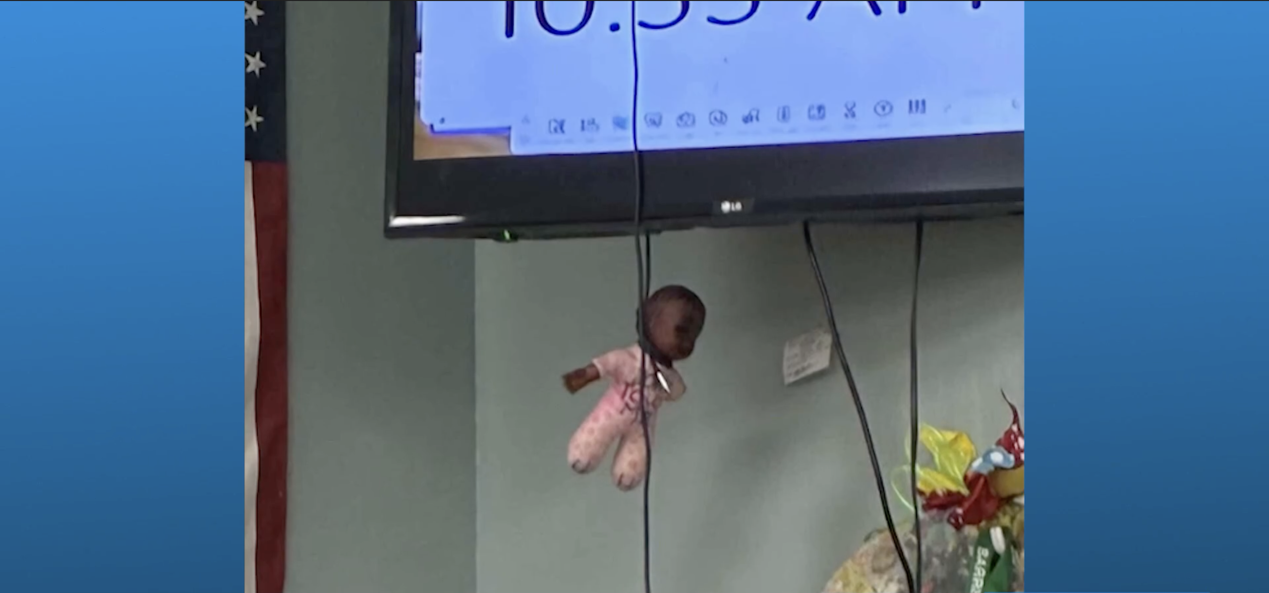 Doll hanging from television