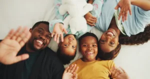 Selfie, above and portrait of family in home for relax, bonding or connection together on weekend. Happy, love and African children with mother and father for photography picture with memory in house
