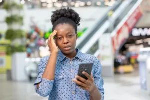 Young black woman feeling stress and headache receiving bad news