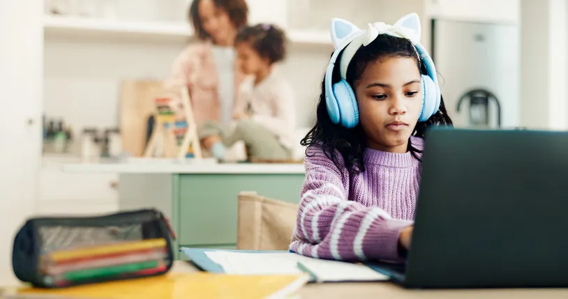 Child, student and headphones at house with laptop, elearning and writing notes for online lesson. Kid, typing and pc in home with notebook, study website and streaming video for learning assessment