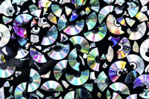 Creative background made of broken CD and DVD data discs