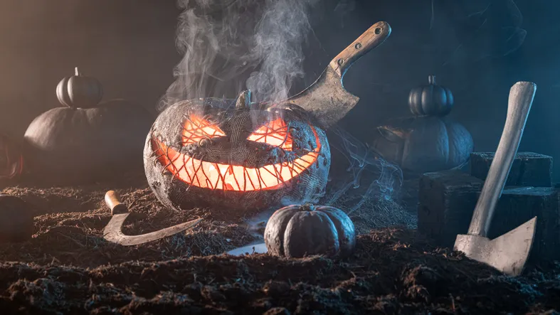 Grinning Jack-o'-lantern monster has fiery orange light inside.